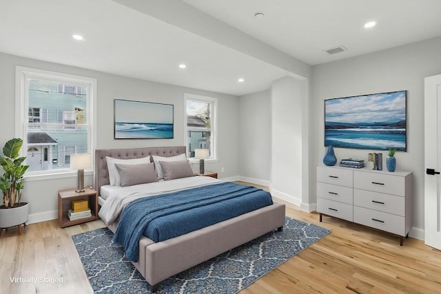 bedroom featuring light wood-type flooring, multiple windows, recessed lighting, and baseboards