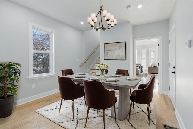 dining space featuring stairway, light wood-type flooring, a chandelier, recessed lighting, and baseboards