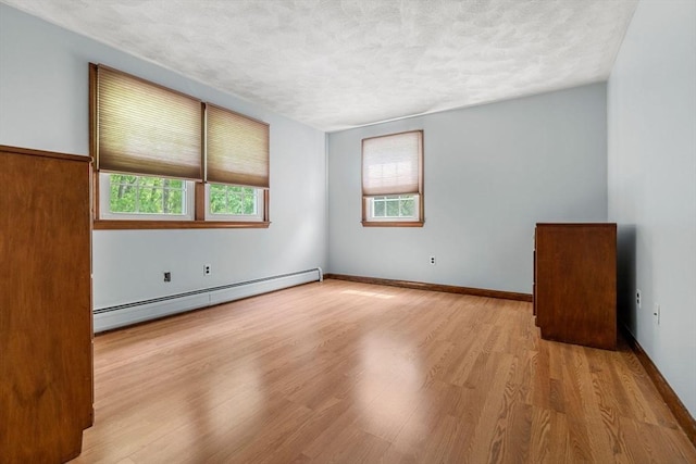 5 Hansen Ave, Burlington, MA 01803 - unfurnished room with a baseboard radiator, wood finished floors, a textured ceiling, cooling unit, and baseboards