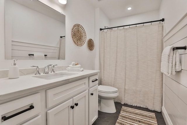 bathroom featuring vanity, curtained shower, and toilet