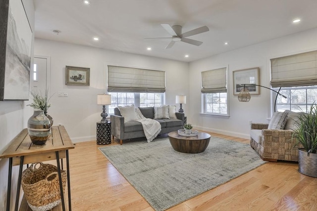 living room with recessed lighting, baseboards, a ceiling fan, and light wood finished floors