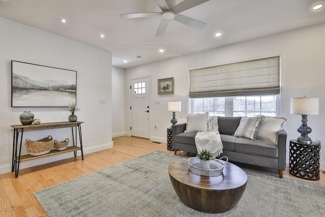 living room featuring recessed lighting, wood finished floors, and baseboards