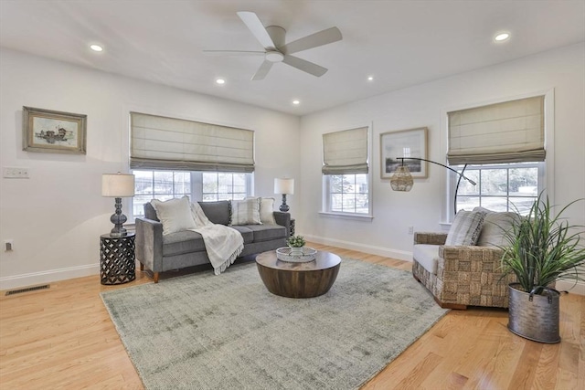 living area featuring visible vents, a ceiling fan, wood finished floors, recessed lighting, and baseboards