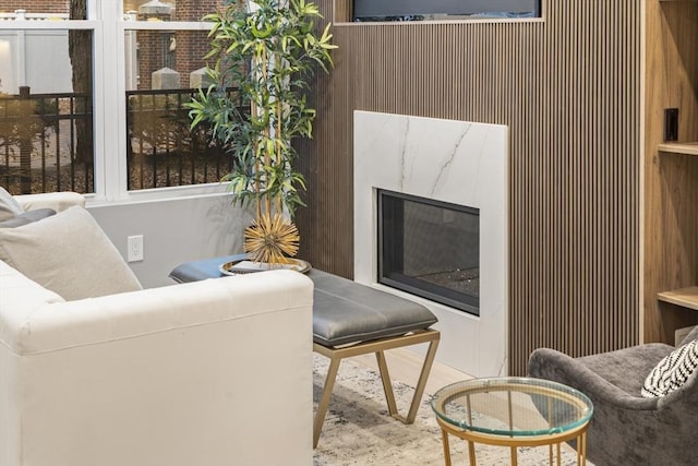 living room featuring wood walls and a fireplace