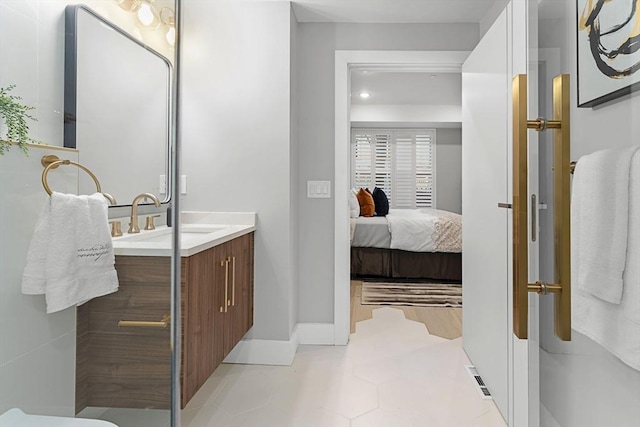 bathroom with tile patterned floors and vanity