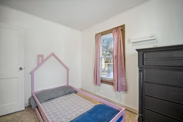 bedroom featuring crown molding and baseboards