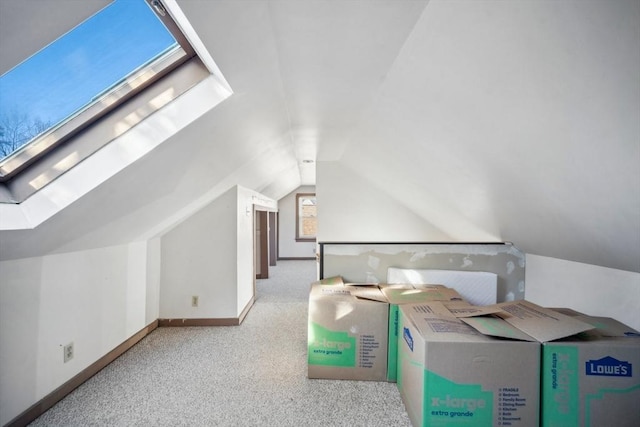 bonus room with lofted ceiling, carpet flooring, and baseboards