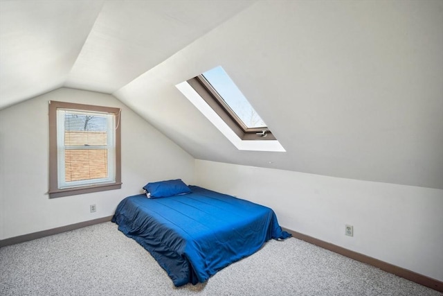 carpeted bedroom with lofted ceiling and baseboards