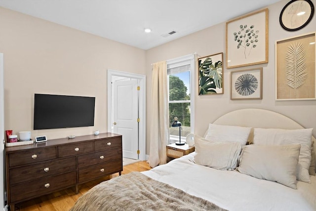 bedroom with light hardwood / wood-style floors