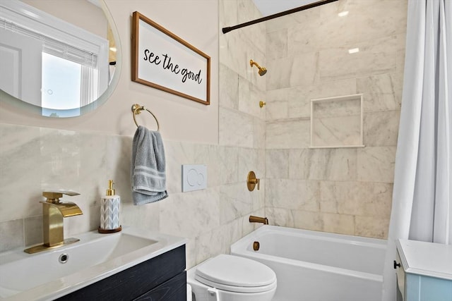 full bathroom with vanity, shower / bath combination with curtain, toilet, and tile walls