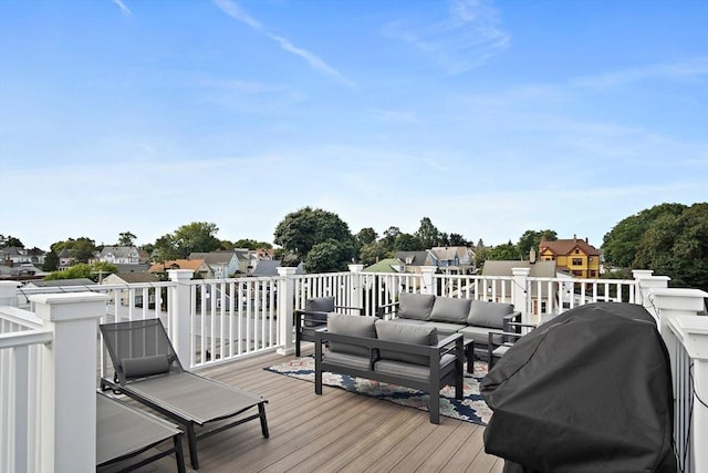 wooden deck with area for grilling and an outdoor hangout area