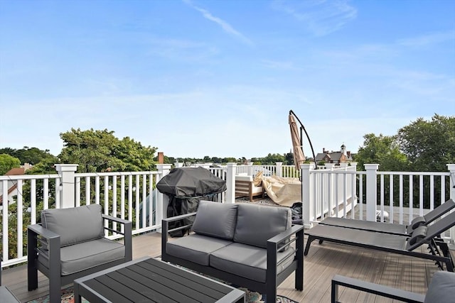 wooden terrace with area for grilling and an outdoor hangout area