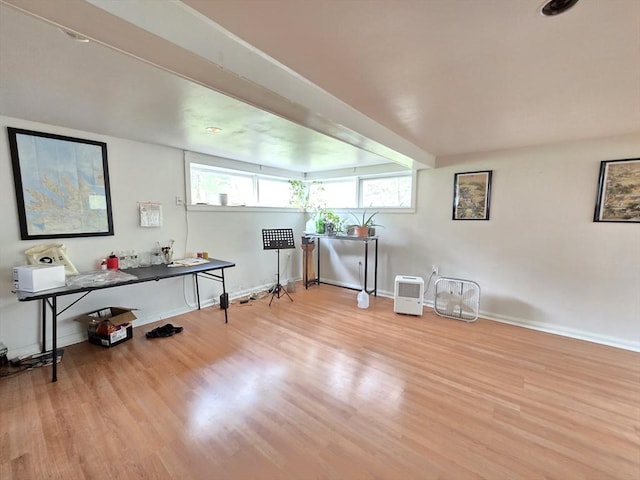 interior space with baseboards and wood finished floors