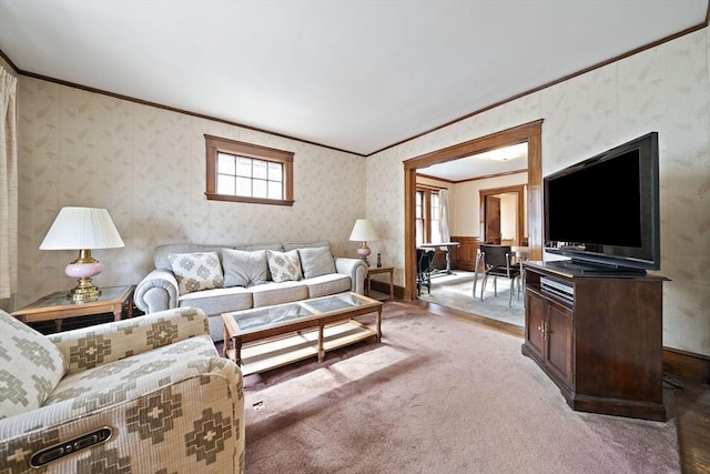 living room with crown molding, wallpapered walls, and light carpet