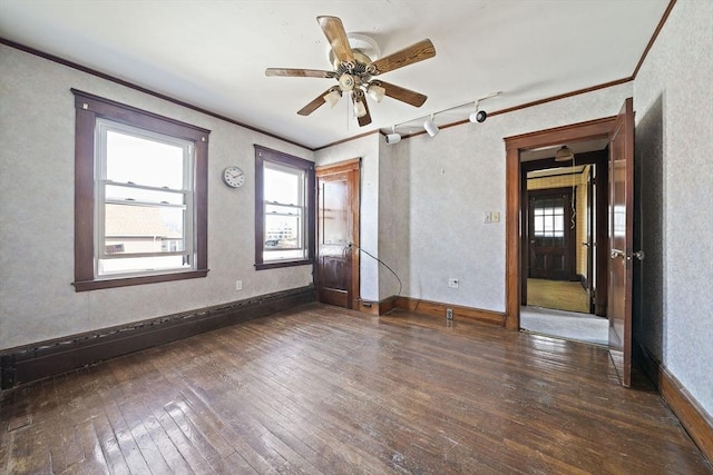 spare room featuring wood-type flooring, ornamental molding, and a healthy amount of sunlight