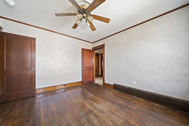 spare room featuring crown molding, a ceiling fan, a textured wall, baseboards, and dark wood finished floors