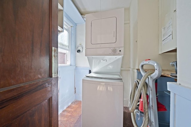 laundry area with stacked washer and dryer
