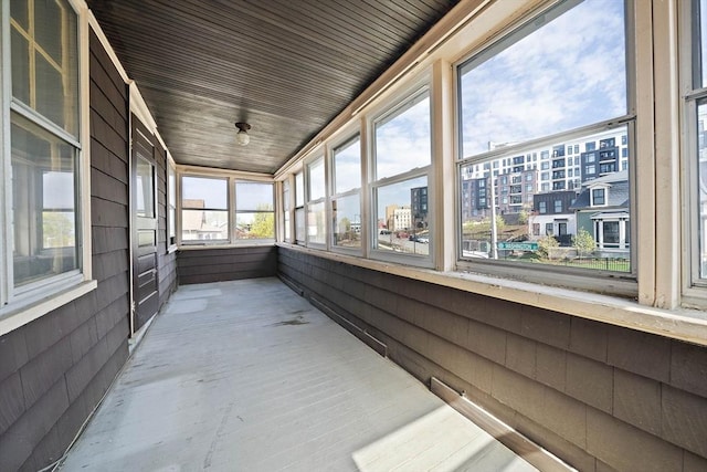 unfurnished sunroom featuring a city view