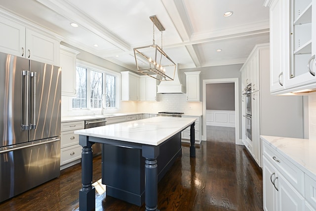 kitchen with appliances with stainless steel finishes, backsplash, white cabinetry, and dark hardwood / wood-style floors