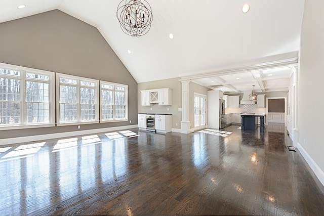 unfurnished living room featuring beamed ceiling, coffered ceiling, dark hardwood / wood-style flooring, and beverage cooler