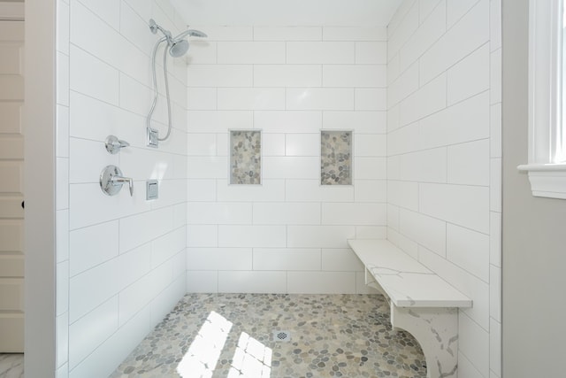 bathroom with tiled shower