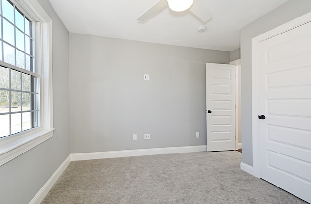 carpeted empty room with ceiling fan