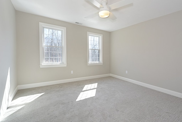 carpeted spare room featuring ceiling fan