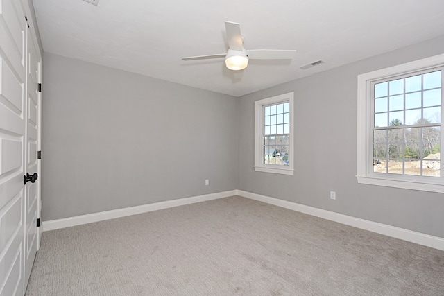 unfurnished room featuring ceiling fan and light colored carpet