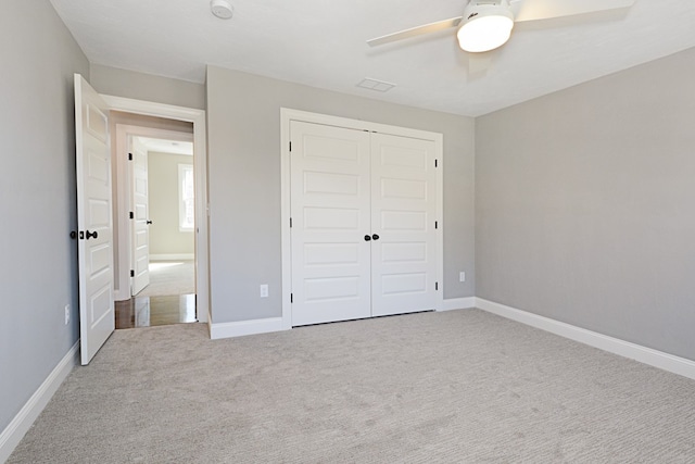 unfurnished bedroom featuring ceiling fan, carpet floors, and a closet