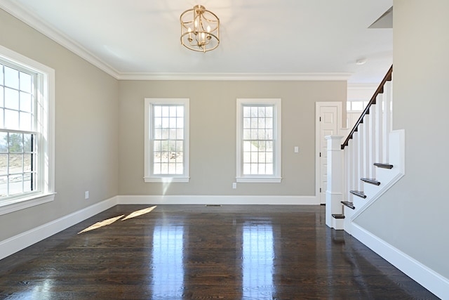 entrance foyer with ornamental molding, dark hardwood / wood-style floors, and a wealth of natural light