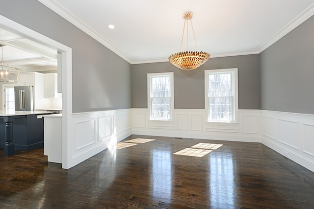 unfurnished room with ornamental molding, plenty of natural light, dark wood-type flooring, and a chandelier