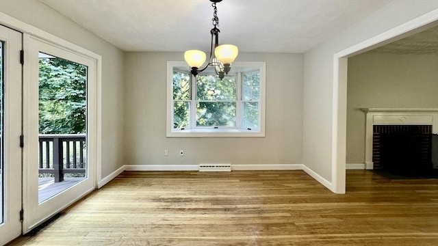 9 Brooks Rd, Sudbury, MA 01776 - unfurnished dining area featuring a chandelier, baseboards, visible vents, and wood finished floors