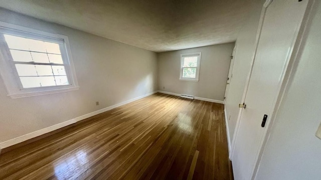 9 Brooks Rd, Sudbury, MA 01776 - unfurnished bedroom featuring a baseboard radiator, baseboards, and wood finished floors