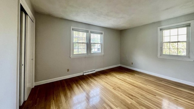9 Brooks Rd, Sudbury, MA 01776 - unfurnished bedroom featuring multiple windows, wood finished floors, and baseboards