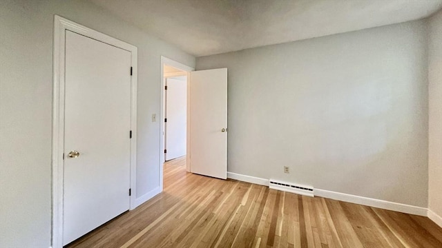 9 Brooks Rd, Sudbury, MA 01776 - unfurnished bedroom with light wood finished floors, visible vents, baseboards, and a baseboard radiator