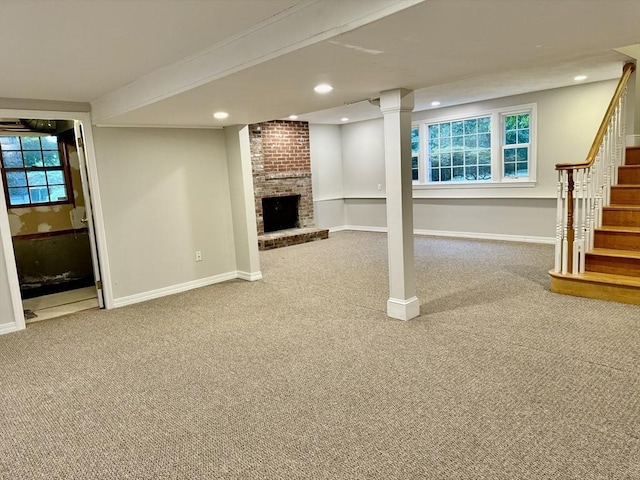 9 Brooks Rd, Sudbury, MA 01776 - below grade area featuring stairs, carpet, recessed lighting, a brick fireplace, and baseboards