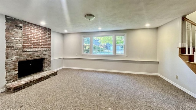 9 Brooks Rd, Sudbury, MA 01776 - unfurnished living room with stairs, recessed lighting, a fireplace, carpet flooring, and baseboards
