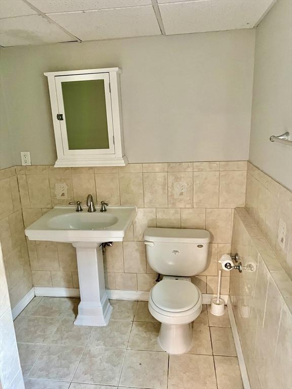 9 Brooks Rd, Sudbury, MA 01776 - bathroom featuring tile walls, toilet, a drop ceiling, and tile patterned flooring