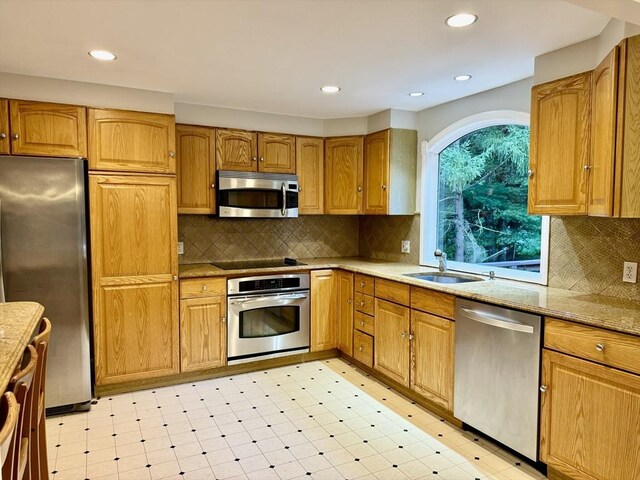 9 Brooks Rd, Sudbury, MA 01776 - kitchen featuring a sink, stainless steel appliances, backsplash, and light floors