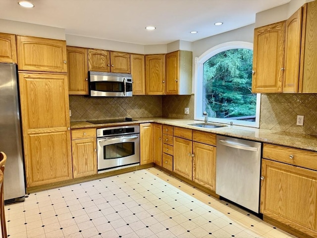 9 Brooks Rd, Sudbury, MA 01776 - kitchen featuring appliances with stainless steel finishes, decorative backsplash, light floors, and a sink