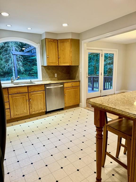 9 Brooks Rd, Sudbury, MA 01776 - kitchen with a sink, tasteful backsplash, dishwasher, light stone counters, and recessed lighting