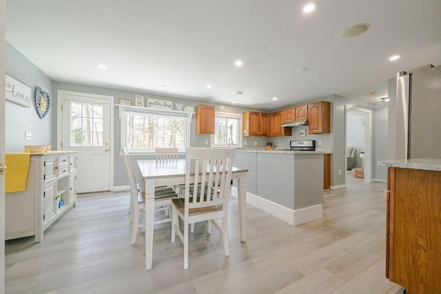 dining room with light wood-style floors, recessed lighting, and baseboards