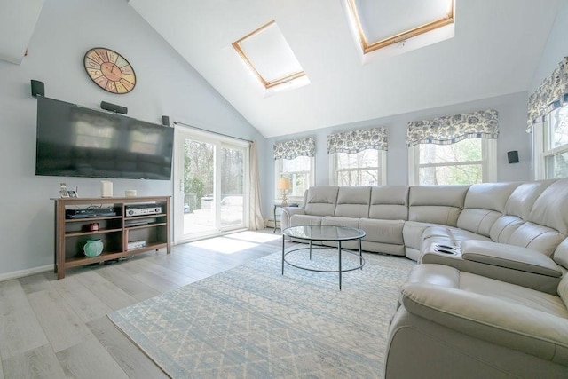 living room with wood finished floors, a skylight, and high vaulted ceiling