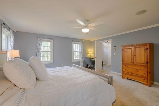 bedroom with light colored carpet, baseboards, ceiling fan, and ornamental molding