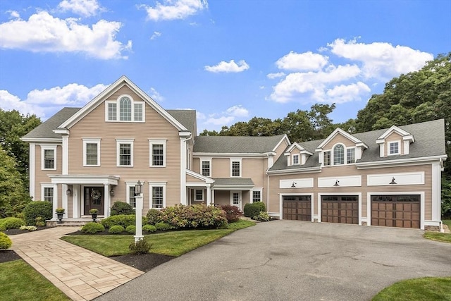 view of front of property with a garage and a front lawn