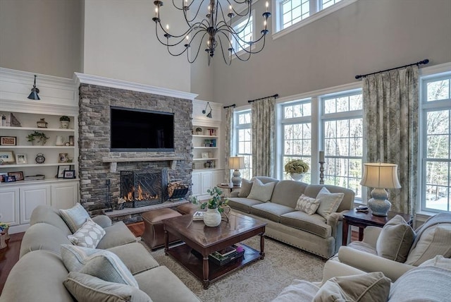 living room with a wealth of natural light, a fireplace, and built in shelves