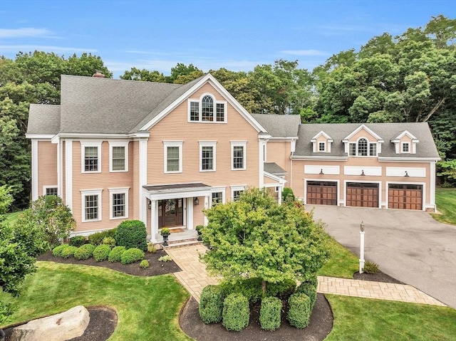 view of front of property featuring a garage and a front lawn