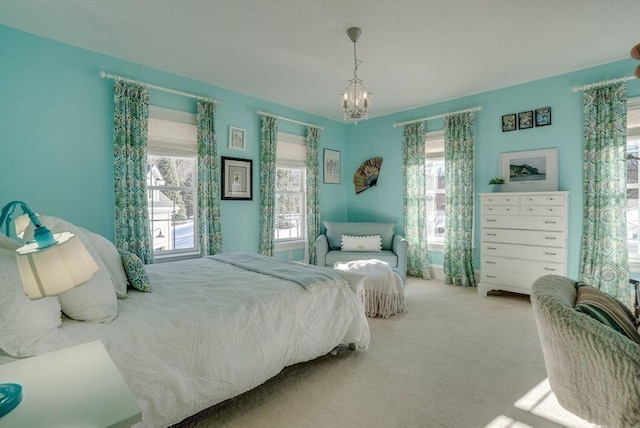 carpeted bedroom featuring a chandelier