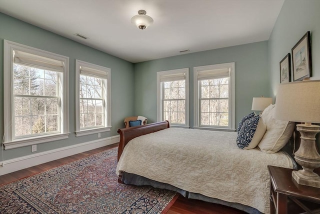 bedroom featuring hardwood / wood-style flooring and multiple windows