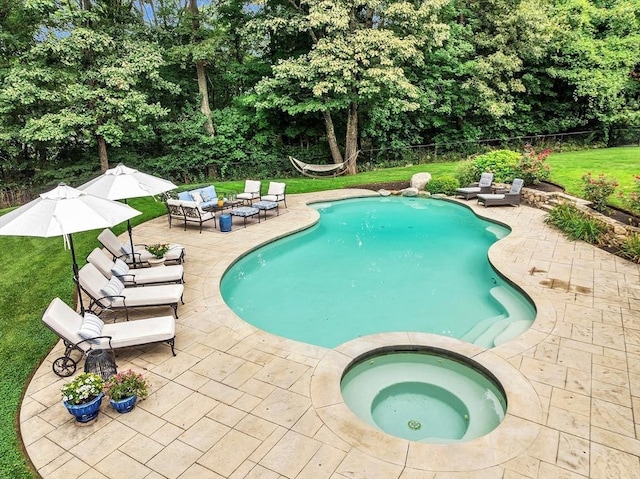 view of pool with a yard, a patio area, outdoor lounge area, and an in ground hot tub